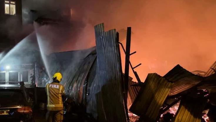 Large pieces of wooden debris and large flames