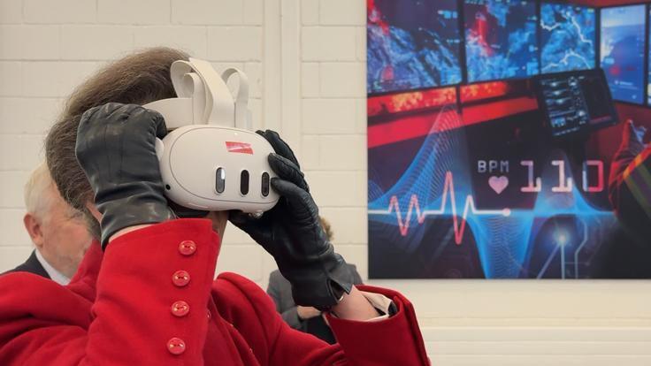 A photo of The Princess Royal trying on a virtual reality headset at the Fire Station College