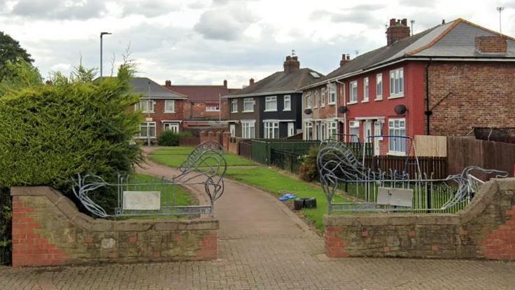 A row of houses with a path in front