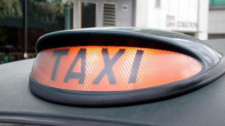 A taxi light on top of a vehicle