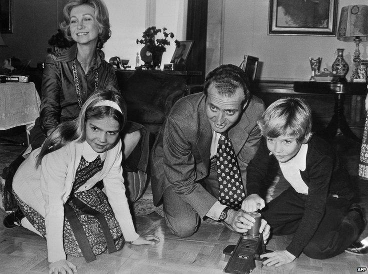 A file photo taken in February 1976 shows King Juan Carlos of Spain and his wife Queen Sophia of Greece, playing with their children Crown Prince Felipe, 8, and daughter Elena, 12, in the Zarzuela Palace in Madrid