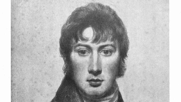 A self portrait of John Constable. It is a black and white chalk and pencil drawing. He depicted himself with dark hair that rests over his forehead and he wears a dark jacket with a large collar and a white cravat around his neck. He is expressionless and has dark eyes.