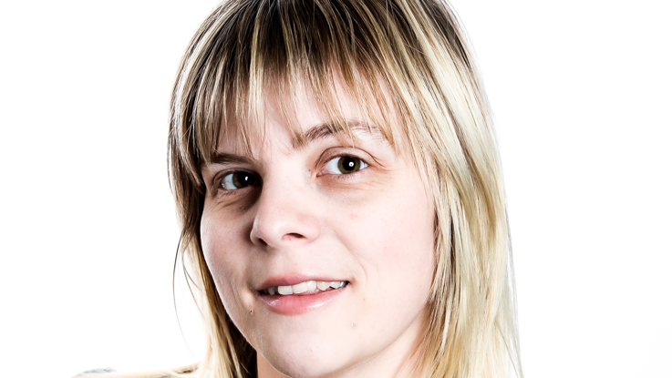 Michelle has long blonde and brown hair and a fringe. She is smiling at the camera in a tight headshot.