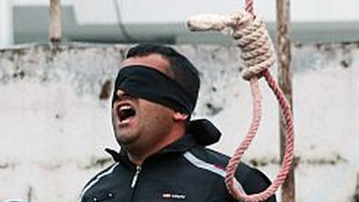 Balal, who killed Iranian youth Abdolah Hosseinzadeh in a street fight with a knife in 2007, reacts as he stands in the gallows during his execution ceremony in the northern city of Noor on April 15, 2014. Samereh Alinejad, the mother of Abdolah Hosseinzadeh spared the life of Balal, her son's convicted murderer, with an emotional slap in the face as he awaited execution prior to removing the noose around his neck.