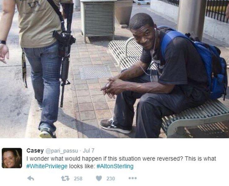 Tweet of black man sitting on bench as whote man with assault rifle passes by