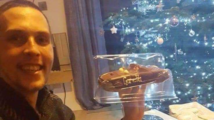 A photo of Gareth holding a chocolate car with his name on it