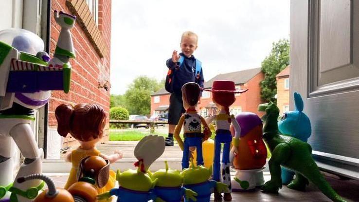 Vinnie on his first day of school waving to his Toy Story toys.
