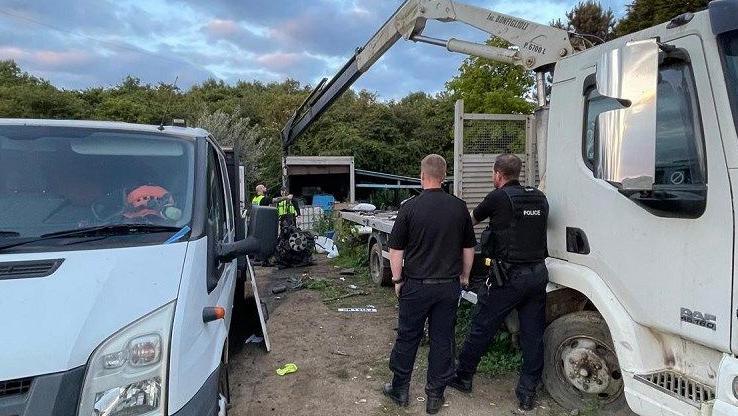 A van with vehicle parts near it