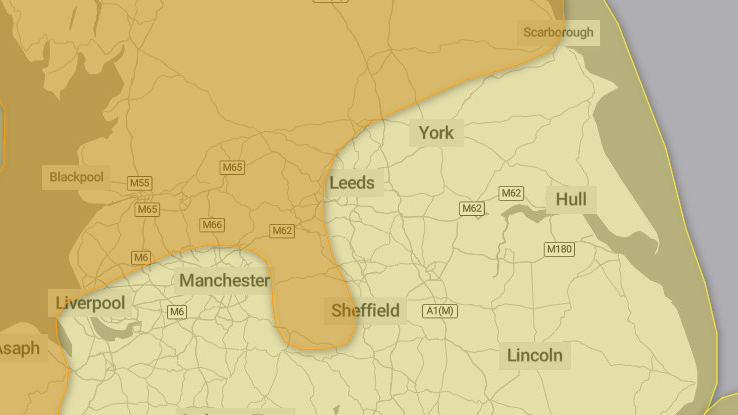 A map of northern England showing an amber area stretching across North and West Yorkshire and Lancashire. The rest of the map is yellow, indicating less severe weather.