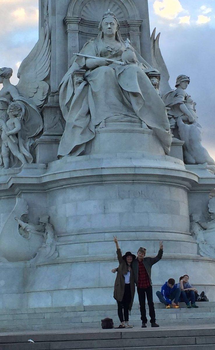 Tammy Daubney and son under statue of Queen Victoria