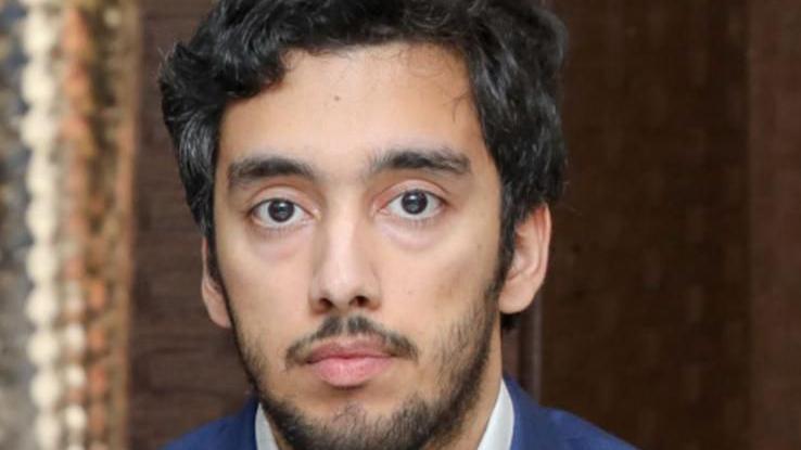 Ali Durrani in a picture. He is an Asian man wearing a smart suit. He has thick black hair and a beard.