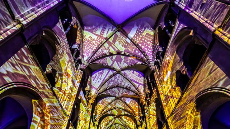 A yellow light show inside Chichester Cathedral.