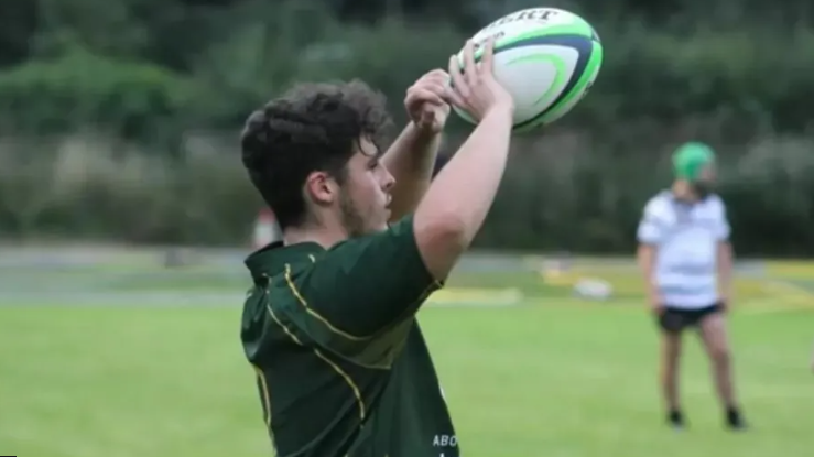 Dylan Price playing rugby