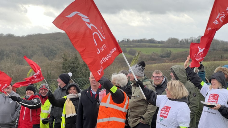 Workers holding flags on a picket line