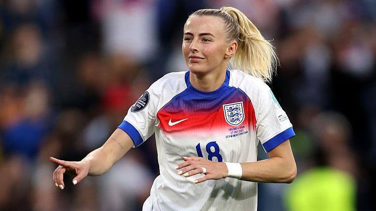 chloe kelly celebrating a goal wearing a football kit