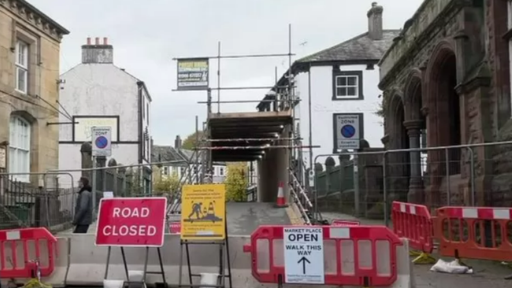 The covered walkway allowing pedestrian access over the bridge at Cockermouth