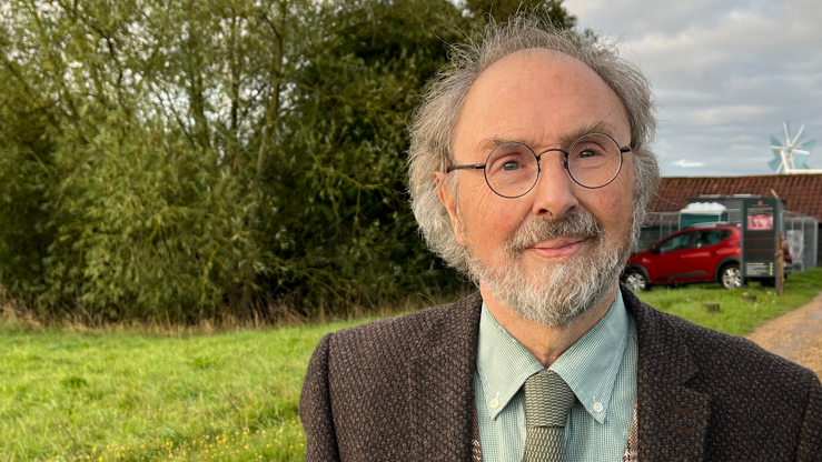 A head and shoulders image of Jonathan Sullivan. He is wearing glasses and a shirt and tie with a blazer over the top. 