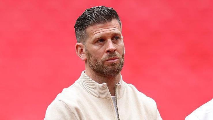 Luke Garrard lines up for the national anthem before the National League promotion final