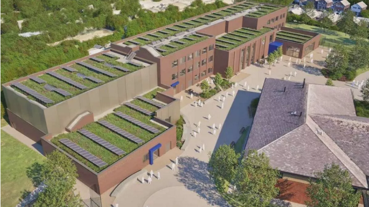 A computer generated view of the new school plan from above, with banks of panels and grass roofs visible