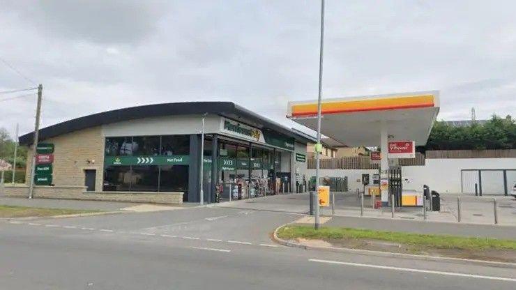 A petrol station on a main road. It is apparently empty with no vehicles parked there.
