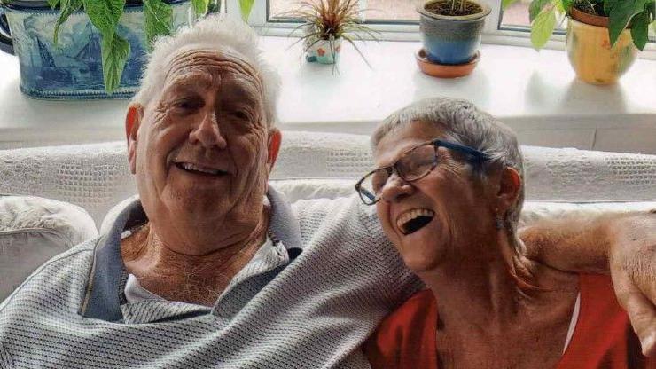 Alan and Ann Shawyer sitting on the sofa in their home
