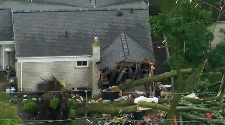 The house in Michigan with a large tree on it, exposing a bedroom where the child was killed