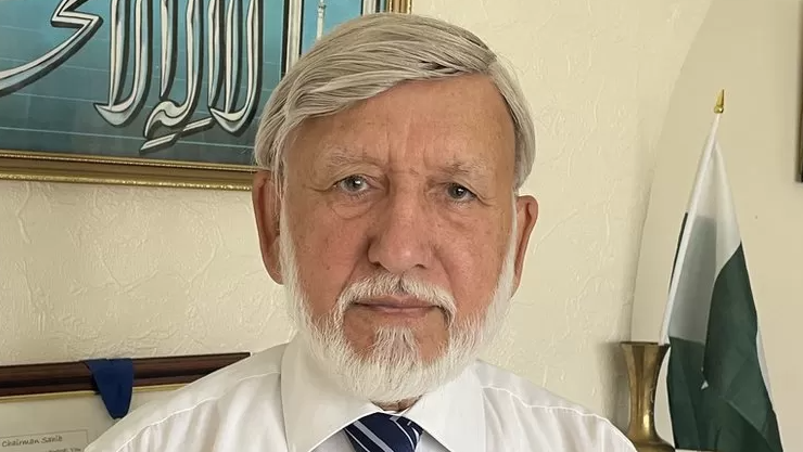 Abdul Choudhuri looking into camera wearing a white shirt and tie 