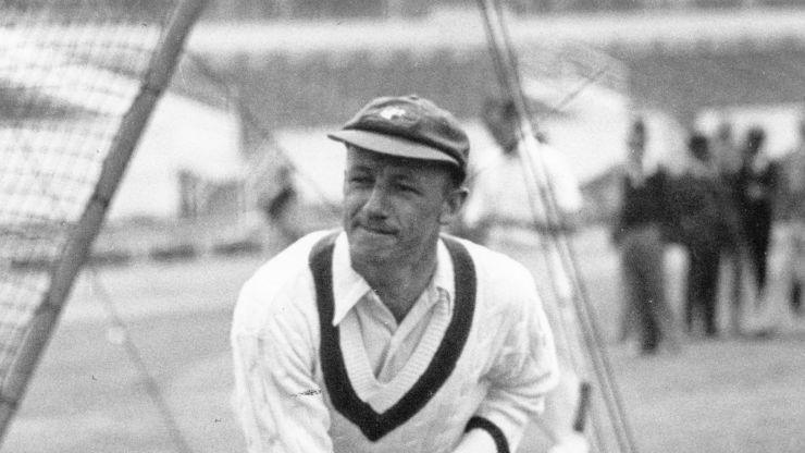 Sir Donald Bradman in action bowling.