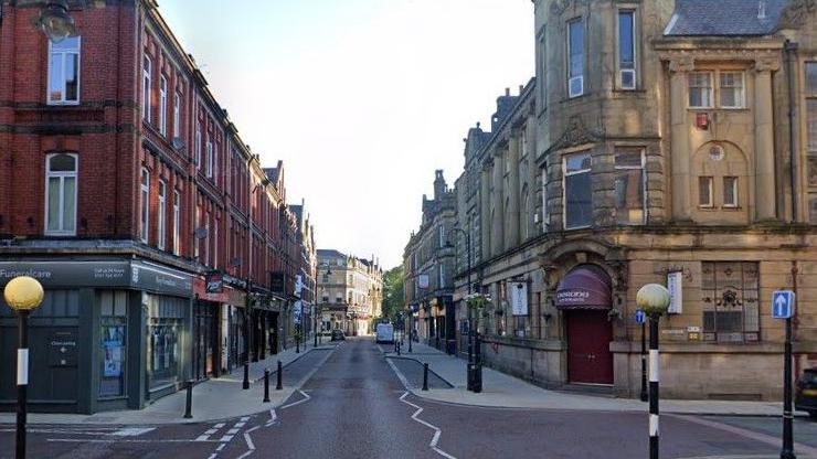 Shops and businesses line a section of Silver Street, in Bury.