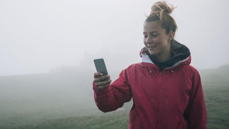 Woman trying to get mobile connection