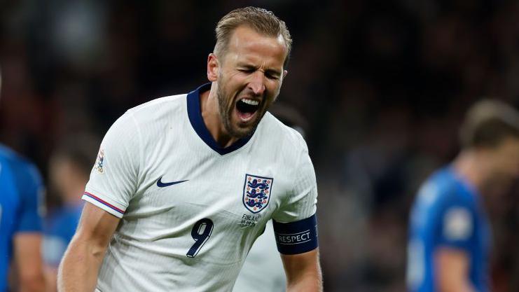 England captain Harry Kane celebrates scoring on his 100th appearance