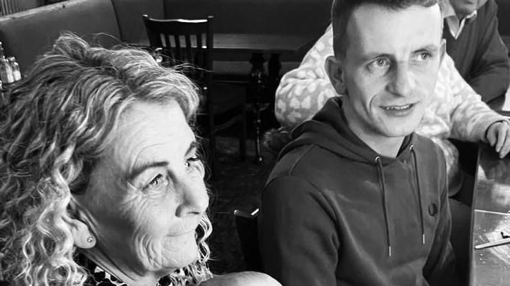 Sue and her son daniel in a black and white photo where they both look happy.