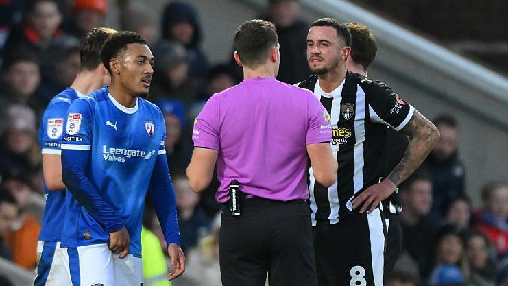 Ollie Norburn is spoken to by the referee in the reverse fixture in December