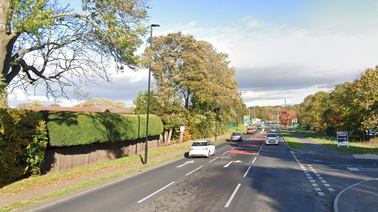 A bypass road, with a third lane in the middle for right turns into the adjacent junction.