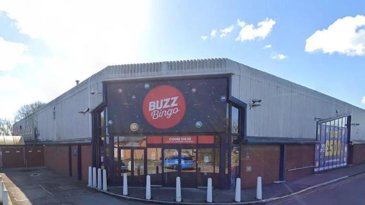 A Buzz Bingo industrial building. The words 'Buzz Bingo' are displayed in large around a red circle with the entrance below.