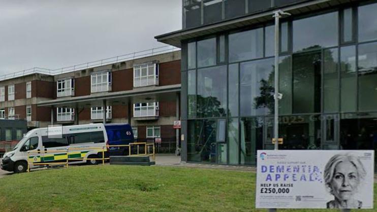 Rotherham hospital building, an ambulance is parked close to an entrance