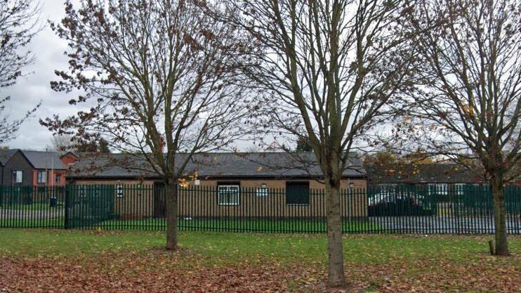 Wheatley Community Library surrounded by a metal fence