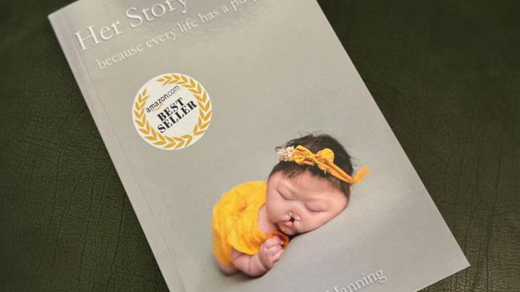 A grey-covered book with an image of Jovie wearing yellow and titled Her Story To Tell