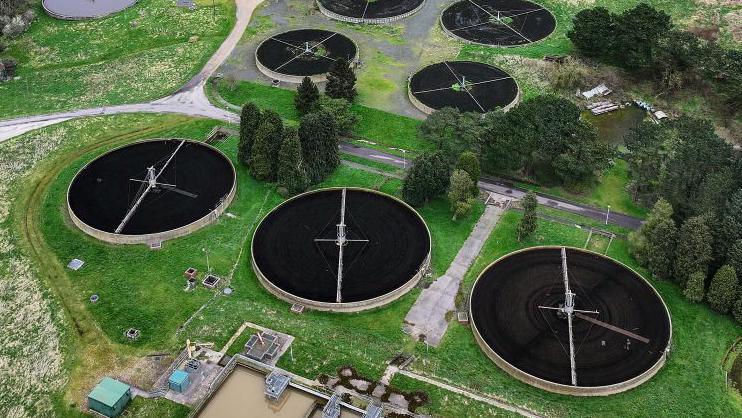 An aerial shots of the round ponds of a water treatment plant.