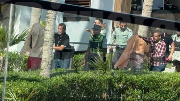 Undercover police officers detaining suspected members of a cartel at a luxury hotel in Mexico.