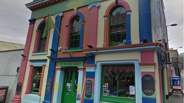 The exterior of the Prince Albert pub in Brighton, painted in several different colours.