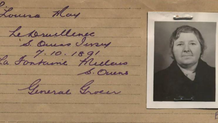 A handwritten card with a black and white photo attached