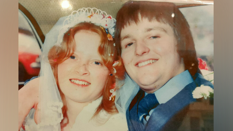 Sean and Susan O'Gorman smile lovingly at the camera on their wedding day.