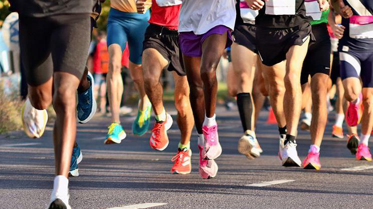 Generic image of runners' feet on road