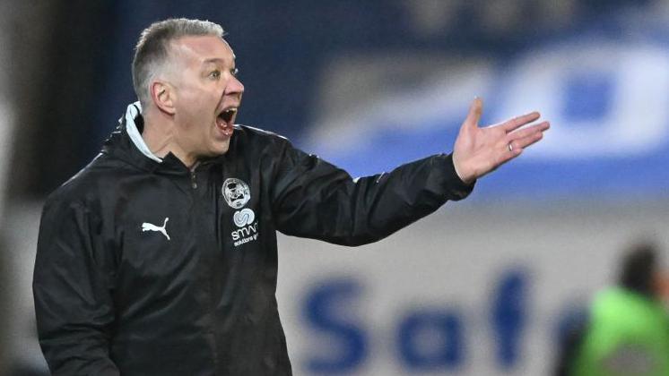 Peterborough boss Darren Ferguson shouts and points during a game