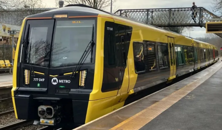 One of the newly introduced dark grey and yellow liveried 777 Class Merseyrail trains