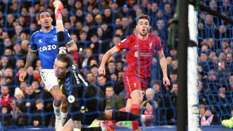 Diogo Jota sends a finish over Everton goalkeeper Jordan Pickford in December 2021.