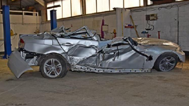 The wreckage of the silver BMW 3 Series car