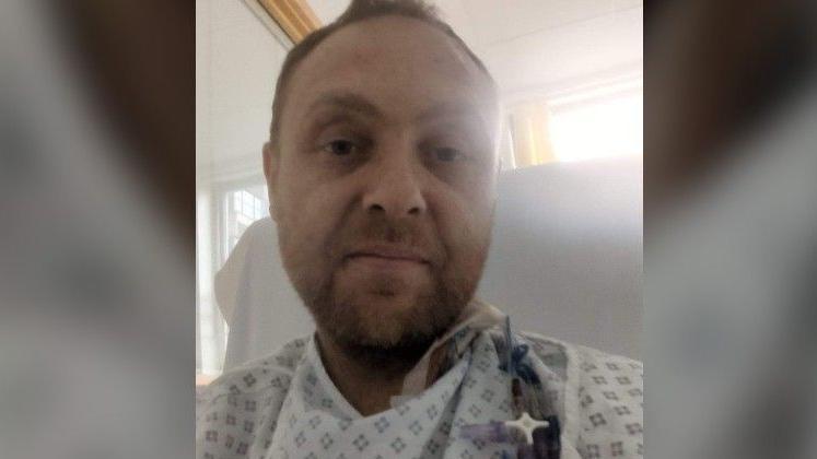 PC Daniel Bird pictured in his hospital gown after a transplant operation