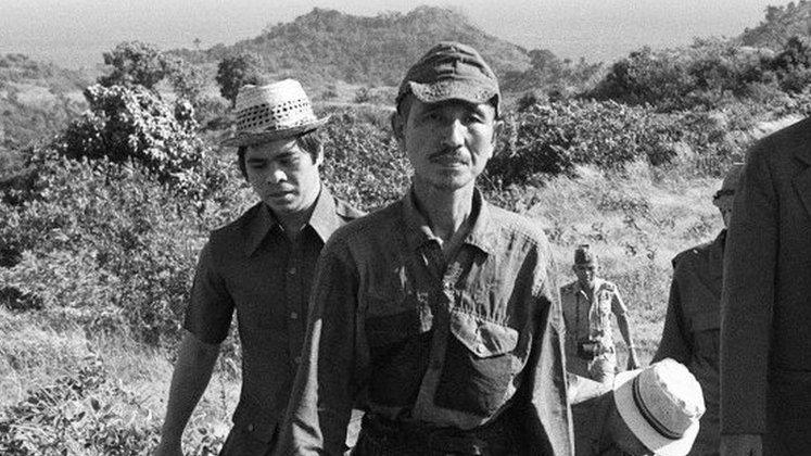 File photo: former Japanese imperial army soldier Hiroo Onoda (second left) walking from the jungle where he had hidden since World War II, on Lubang island in the Philippines, 11 March 1974